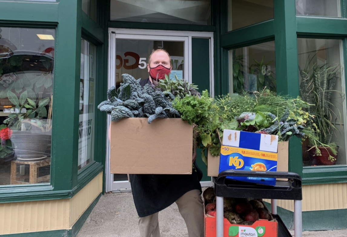 Chef Michael of St John’s Kitchen at The Working Centre holding vegetables harvested from Rockway Gardens in Kitchener, Ontario.