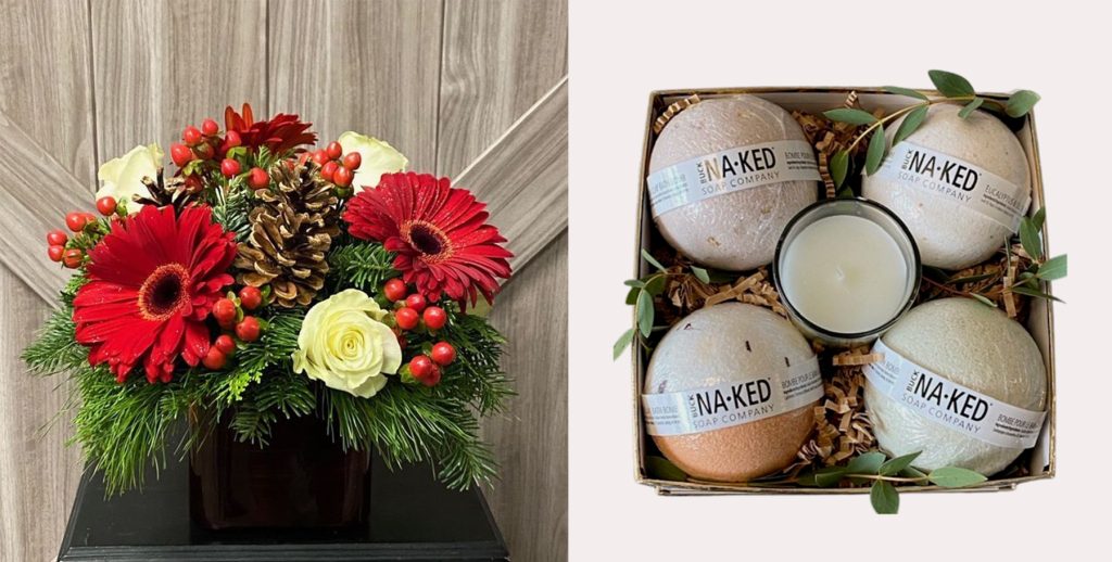 floral arrangement with red flowers on a table and a gift box with bath bombs